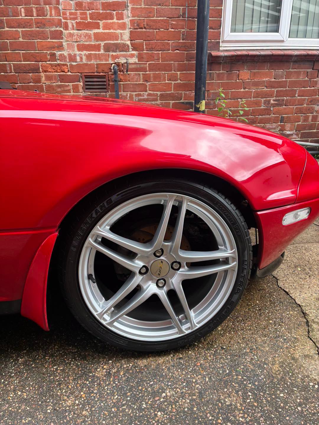 Glossy red Mazda MX5 paintwork and alloy wheel after Fresh Clean’s machine polishing